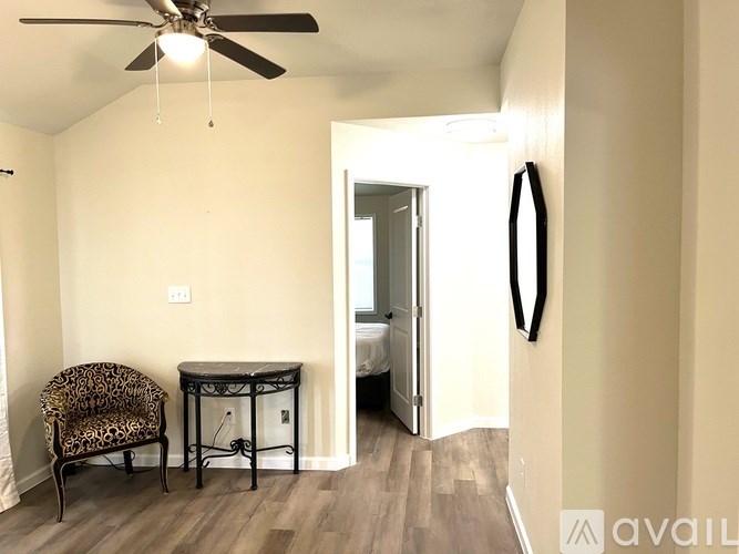 A room with a chair and a table in it.