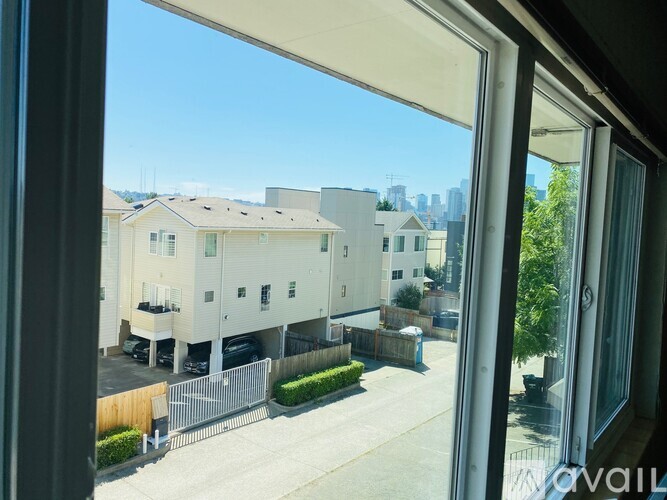 A view from a window looking out at apartment buildings.