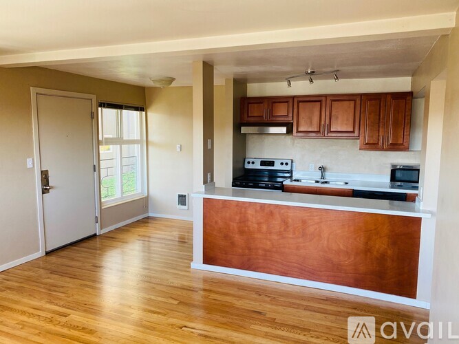 A kitchen with wooden cabinets and a white countertop.