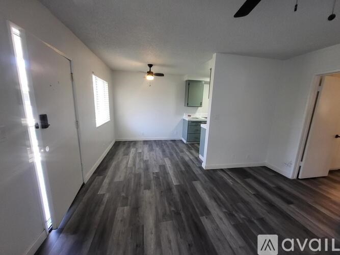 A room with wooden flooring and a ceiling fan.