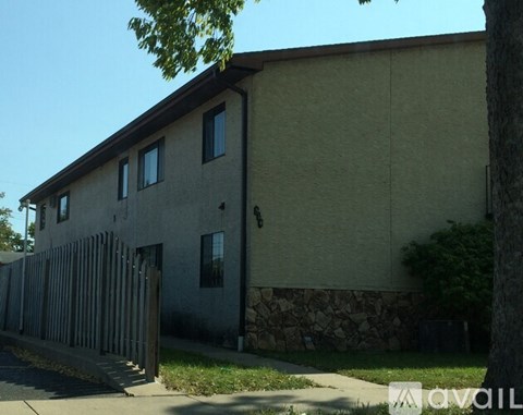 A building with a stone wall and a gate in front.