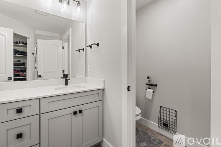 A bathroom with a white sink and a mirror above it.