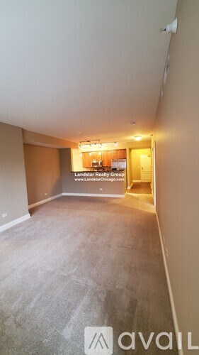 A room with a carpeted floor and a sign that says "Landstar Realty Groups" on the wall.