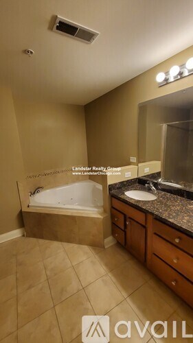 A bathroom with a tub, sink, and mirror.