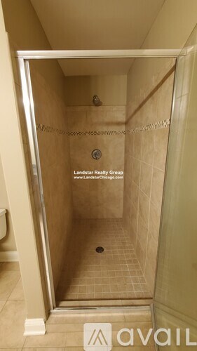 A bathroom with a shower and a toilet.