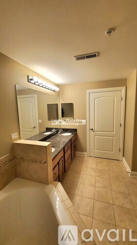 A bathroom with a tub, sink, mirror, and a sign that says "available".