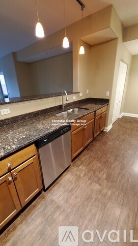A kitchen with wooden cabinets and a granite countertop.