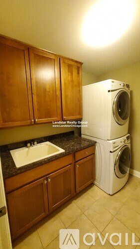 A laundry room with a washer and dryer stacked on top of each other.