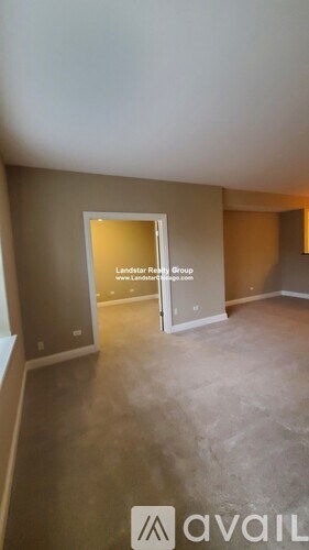 A room with a doorway that says "Landstar Realty Group" on it.