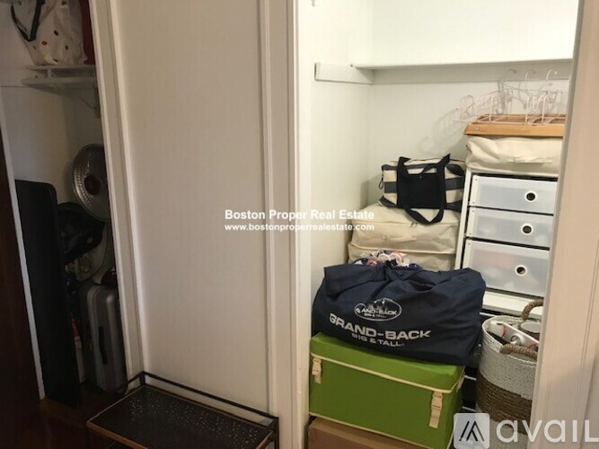 A small closet with a bag that says "Grand-Back" on it.