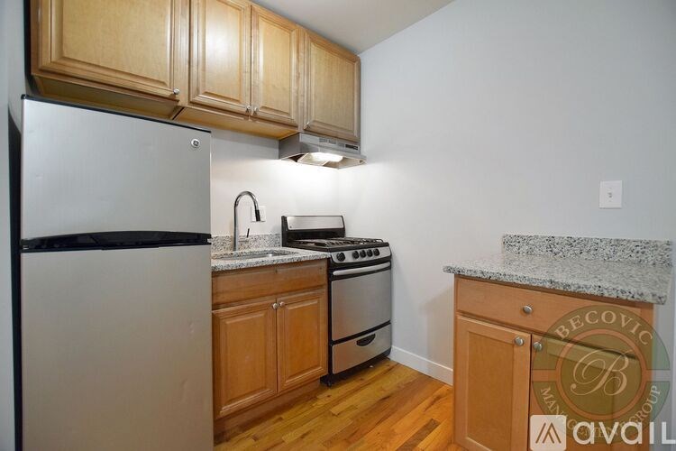 A kitchen with wooden cabinets and a white refrigerator.