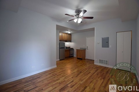 A room with wooden floors and a ceiling fan.