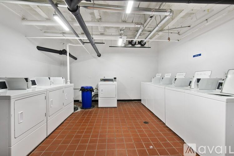 A laundry room with washers and dryers.