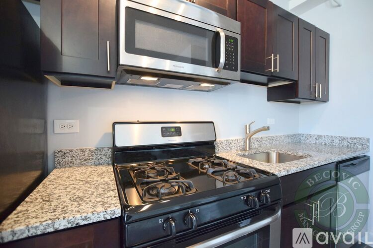 A modern kitchen with a black stove and microwave above it.