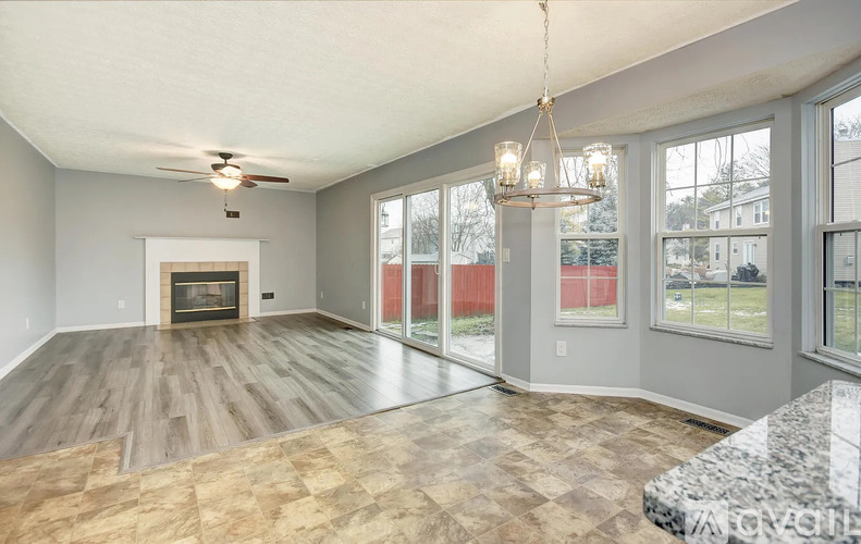 A spacious living room with a fireplace and sliding glass doors.