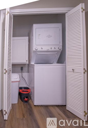 A white washing machine and dryer in a small laundry room.