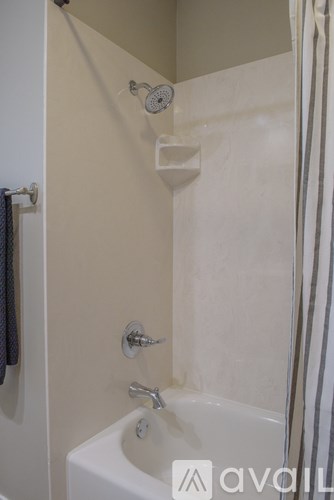 A white sink in a bathroom with a shower curtain.