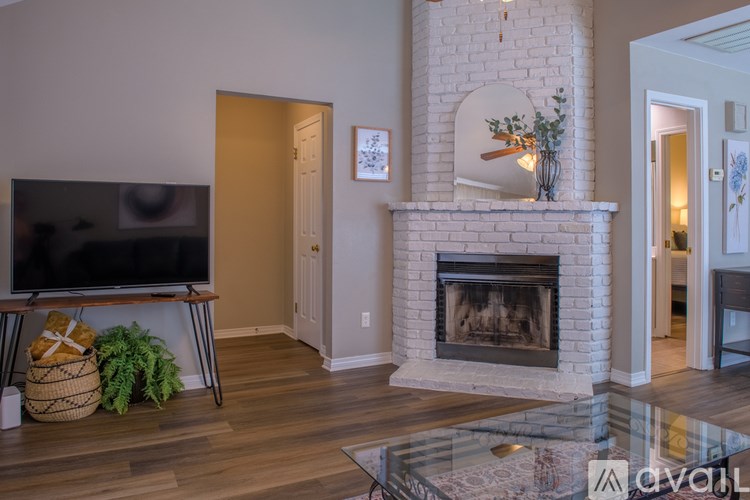 A living room with a fireplace and a television.