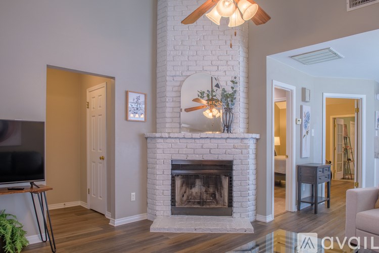 A living room with a fireplace and a television.