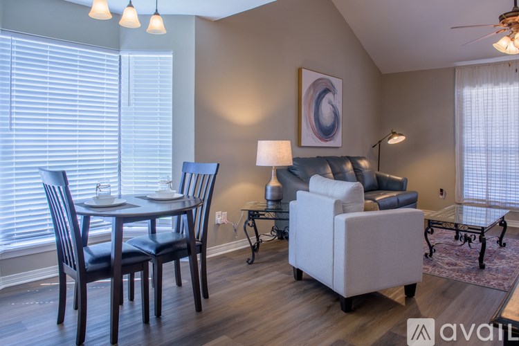 A living room with a dining table and chairs.