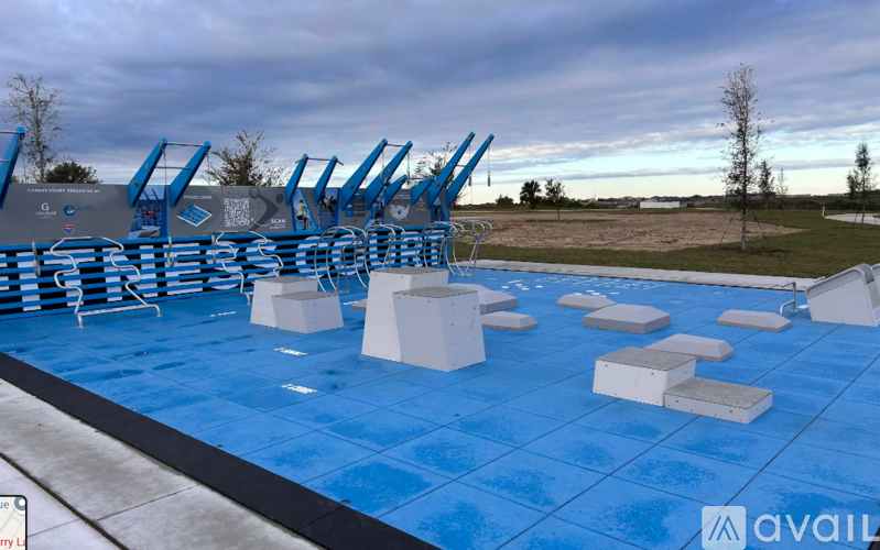 A blue tiled pool area with white steps and blue lounge chairs.