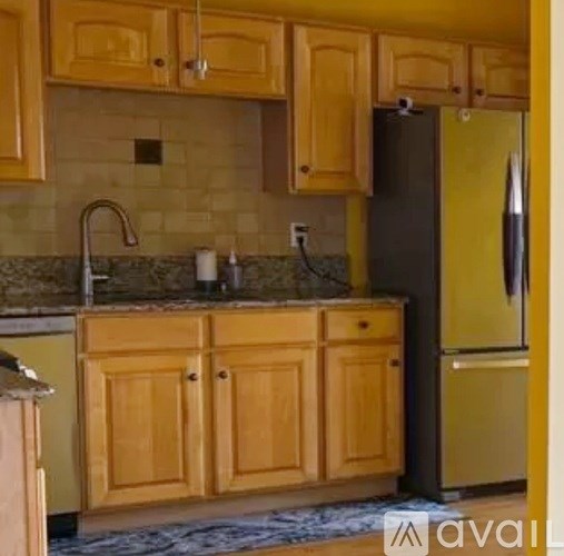 A kitchen with wooden cabinets and a granite countertop.
