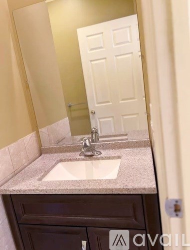 A bathroom with a sink and a mirror.