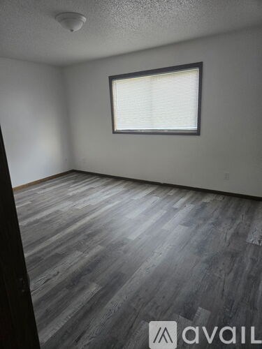 A white apartment building with a walkway in front.