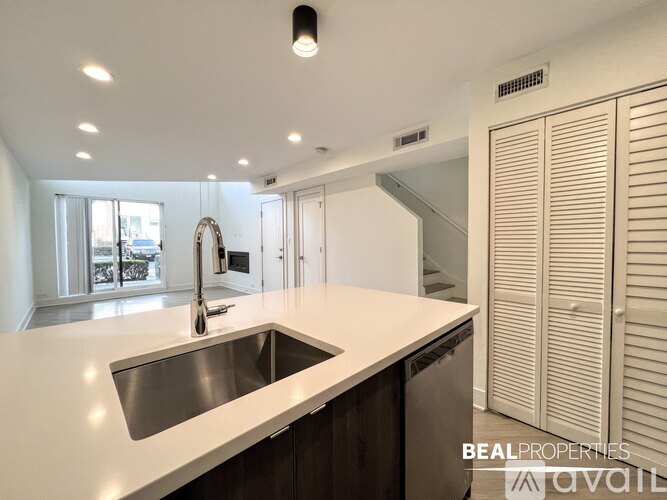 A modern kitchen with a sink and a window.