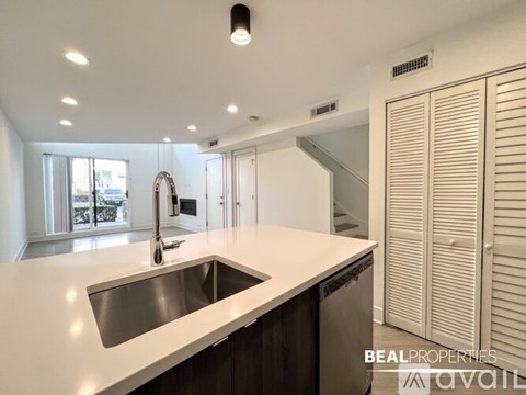 A modern kitchen with a sink and a window.