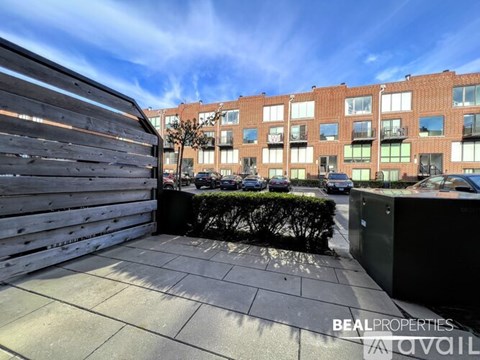 A view of a building with the text "BEALPROPERTIES AVAIL" on the foreground.