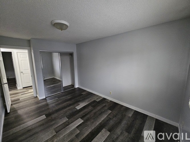 A room with wooden flooring and a white ceiling.