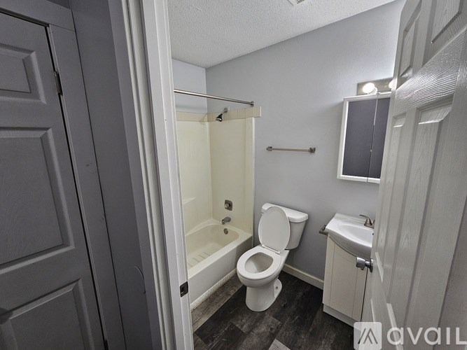 A bathroom with a toilet, sink, and shower.