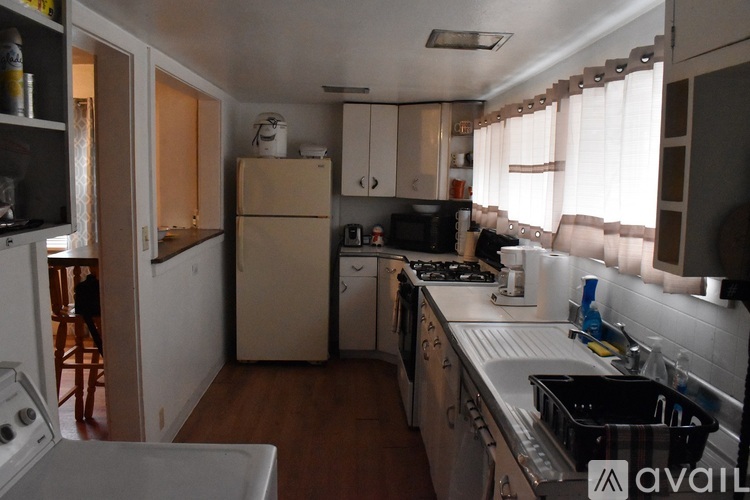 A kitchen with a white oven and a sink.