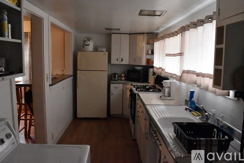 A kitchen with a white oven and a sink.