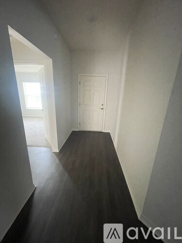A hallway with a door and a window.