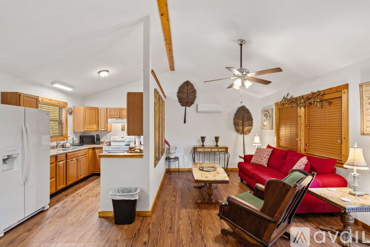 A kitchen with wooden cabinets and a white stove top oven.