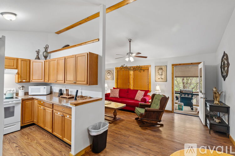 A kitchen with wooden cabinets and a white stove.