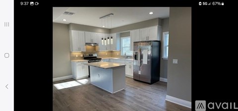 A modern kitchen with stainless steel appliances and a center island.
