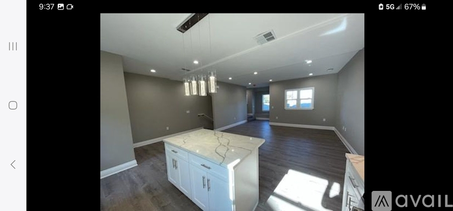 A spacious kitchen with a central island and modern appliances.