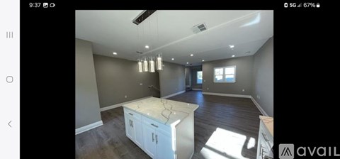 A spacious kitchen with a central island and modern appliances.