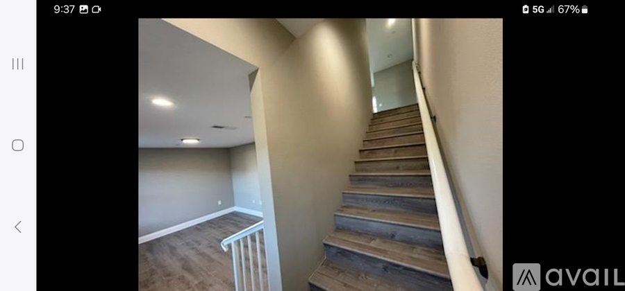 A staircase with wooden steps and a metal railing.
