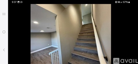A staircase with wooden steps and a metal railing.