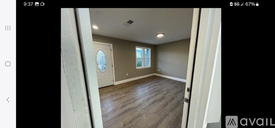 A room with wooden flooring and a window is available for rent or sale.