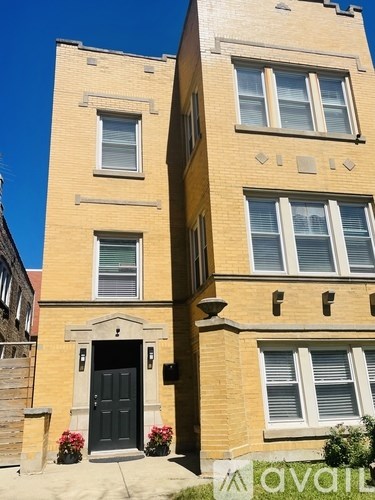 A two-story building with a black door and windows.