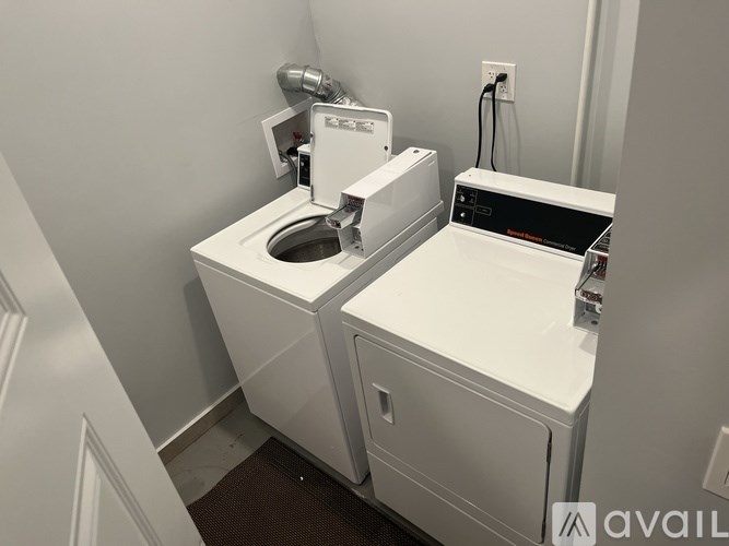 A white toilet with a white tank and a white base with a black top.