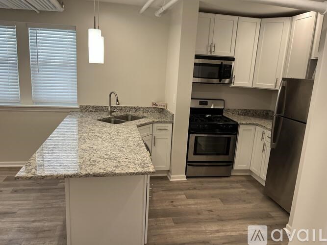 A kitchen with granite countertops and stainless steel appliances.