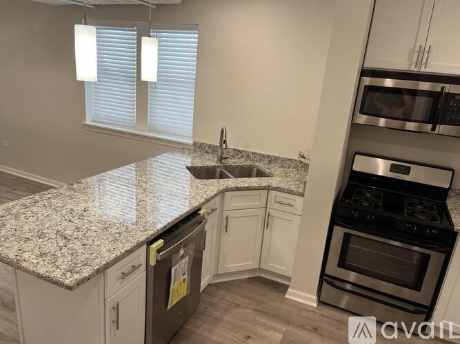 A kitchen with granite countertops and stainless steel appliances.