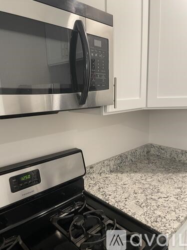 A modern kitchen with a stove top oven and microwave.