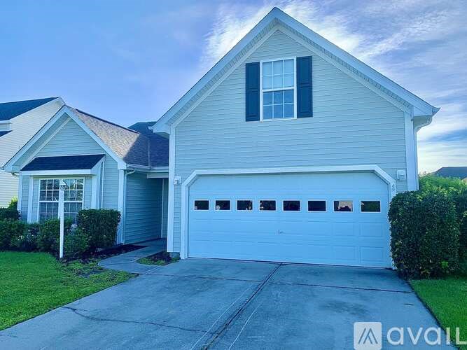A two-story house with a garage is available for sale.
